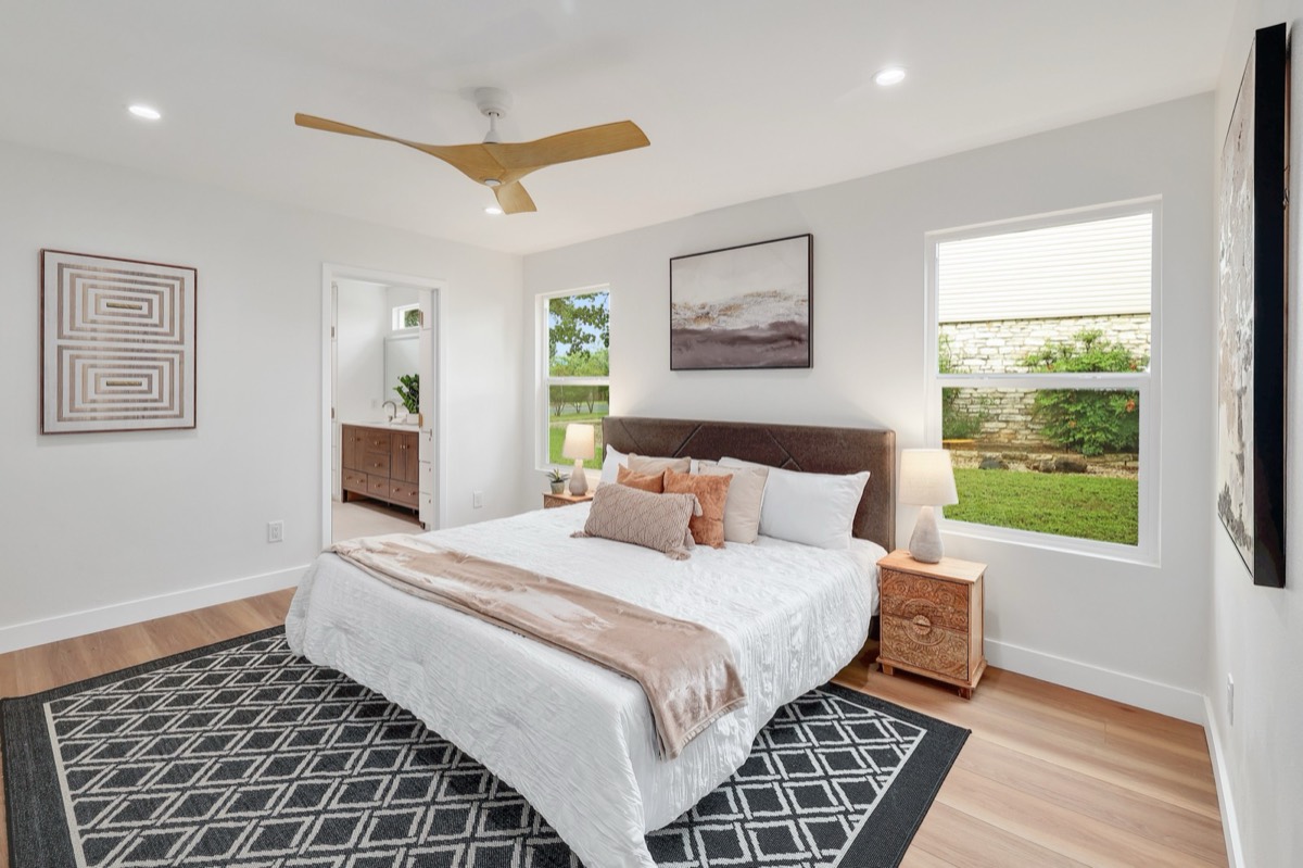 Primary bedroom with ensuite and backyard views