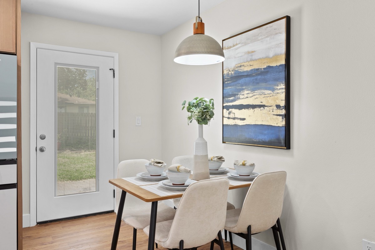 Dining nook with pendant light and artwork