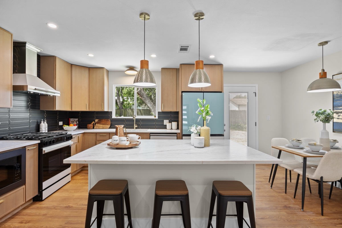 Modern kitchen with marble island and pendant lighting